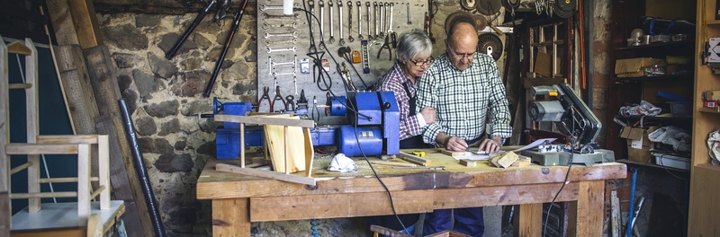 Senior couple working in a carpentry workshop