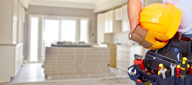 Builder handyman with construction tools.