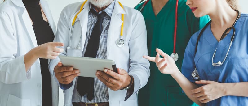 Group of doctor with tablet on white background